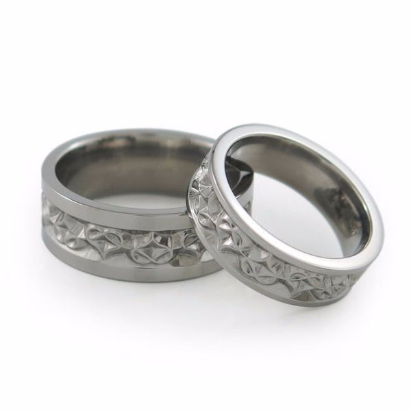 Amore titanium wedding set. Heart shape carvings around the ring. 