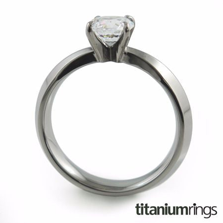 The Cleopatra titanium engagement ring features a dainty single prong setting and a slender band. 5mm stone. 